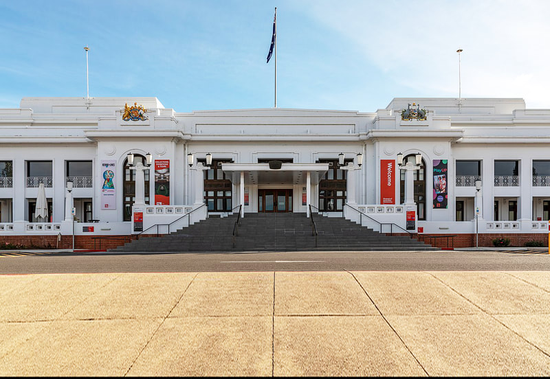 The front entrance of Old Parliament House on a sunny afternoon.