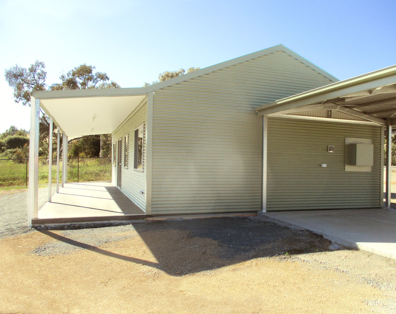A neat cottage, new build, corrugated outside and wide verandah.